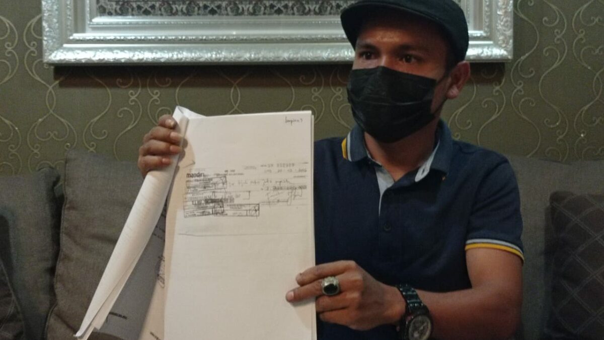 Kuasa Hukum Irma Suryani, Jumintar Napitupulu menunjukkan fotokopi barang bukti yang disebut cek kosong. (Klausa.co)