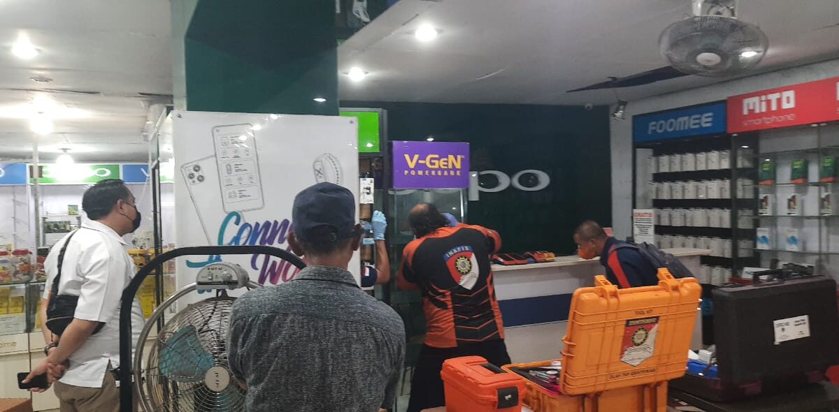 Pihak kepolisian saat melakukan olah TKP di toko ponsel. (Klausa.co)