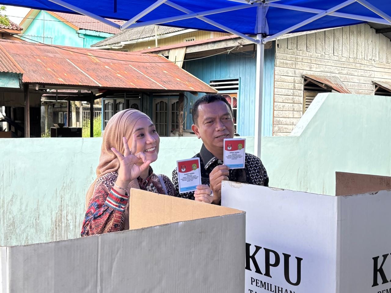 Calon Bupati Kukar nomor urut 03, Dendi Suryadi bersama istri melakuka pemungutan suara ulang.